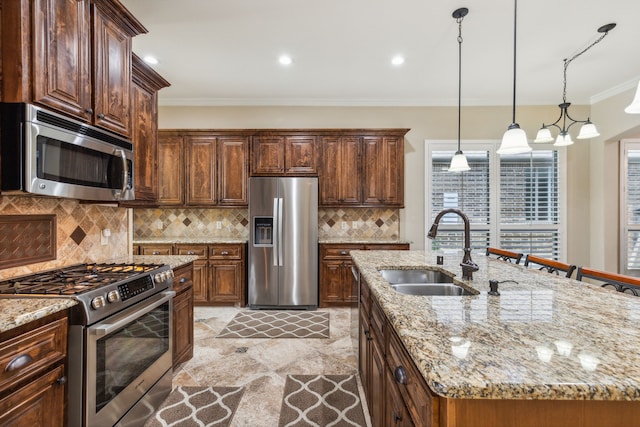 kitchen with sink, light tile patterned floors, an island with sink, and stainless steel appliances