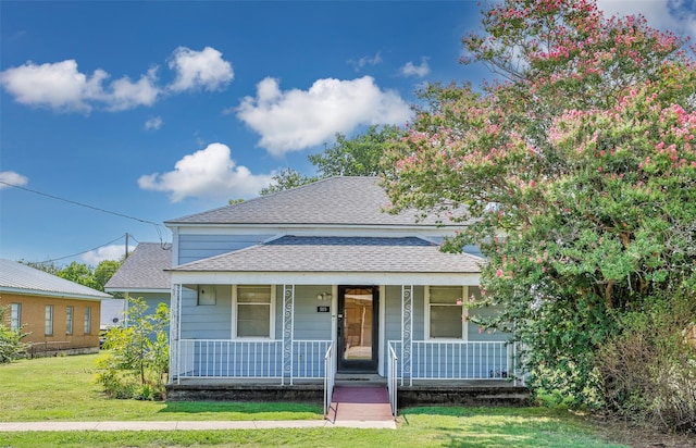 view of front of home with a porch and a front lawn