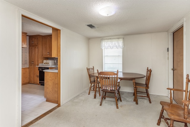 dining space featuring a textured ceiling and light tile patterned floors