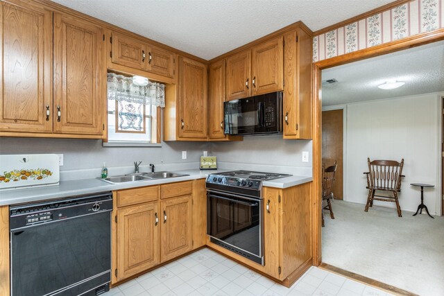 kitchen with sink, a textured ceiling, black appliances, and light colored carpet