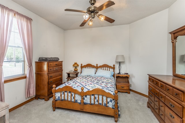 carpeted bedroom with a textured ceiling and ceiling fan