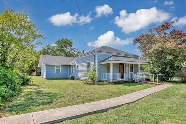 view of front of home featuring covered porch, central air condition unit, and a front lawn