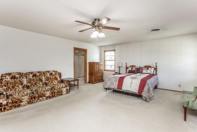 carpeted bedroom featuring a textured ceiling and ceiling fan