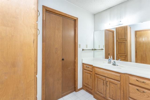 bathroom with vanity, tile patterned floors, and a textured ceiling