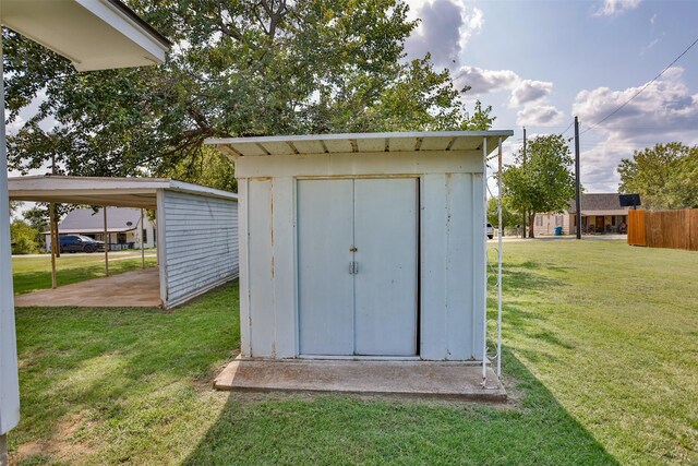 view of outdoor structure featuring a lawn