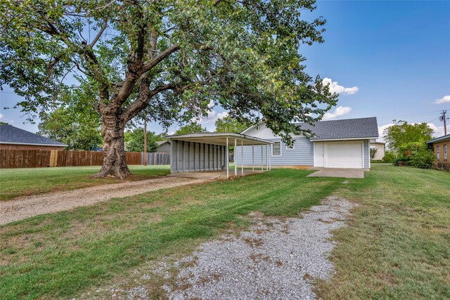 back of property featuring a carport and a yard