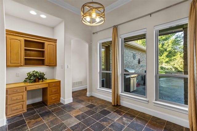 interior space featuring crown molding and built in desk