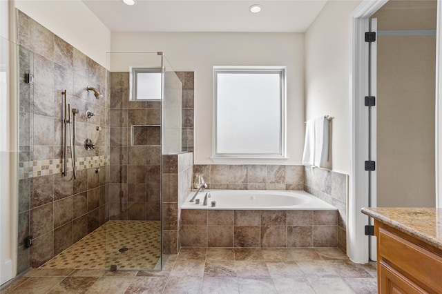 bathroom featuring vanity and independent shower and bath