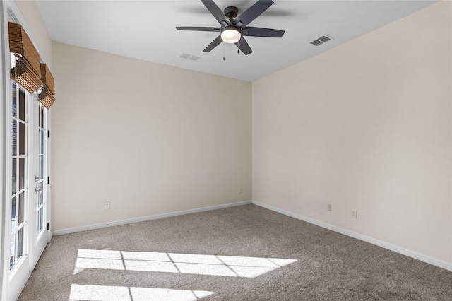 carpeted spare room with french doors and ceiling fan