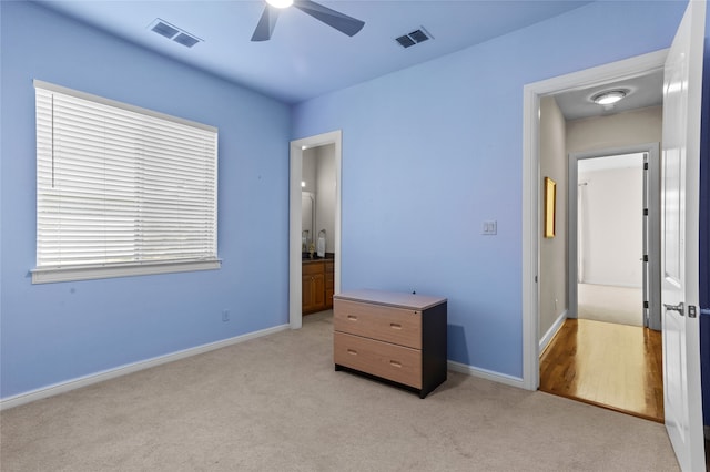 unfurnished bedroom featuring ceiling fan and light colored carpet