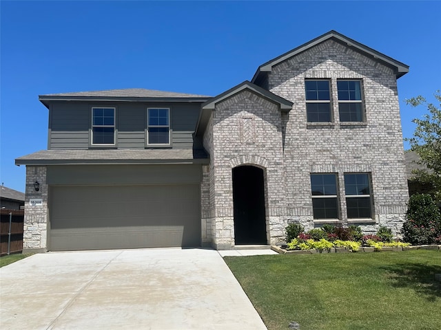 view of front of home with a garage and a front yard