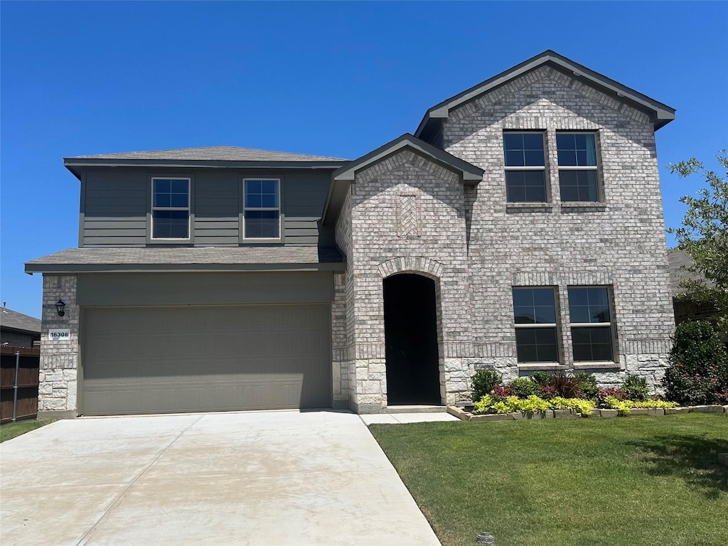 view of front of property with a garage and a front yard