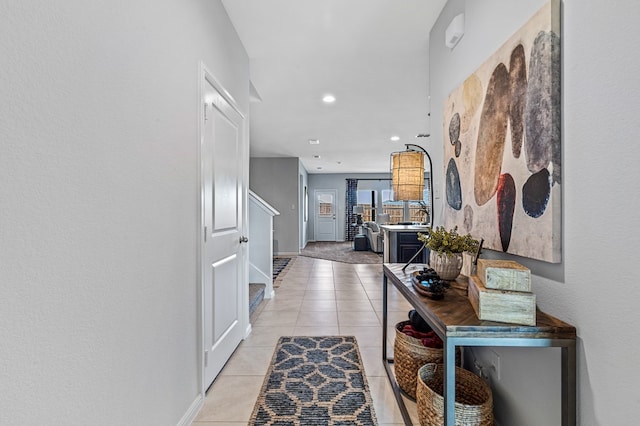 hall with light tile patterned floors