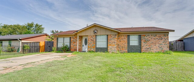 ranch-style home with a front lawn