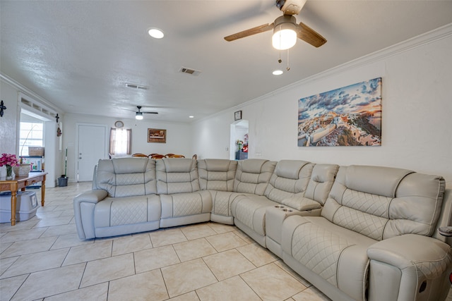 tiled living room with ornamental molding and ceiling fan