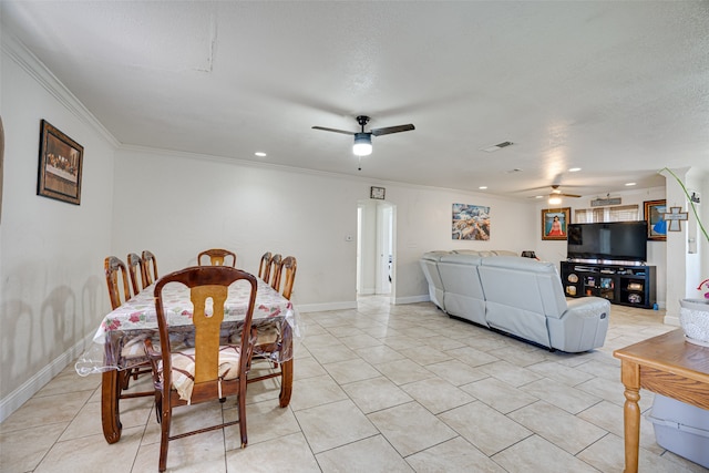 tiled dining area featuring ceiling fan and crown molding