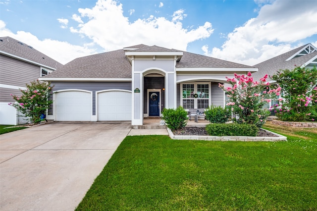 view of front facade featuring a garage and a front lawn