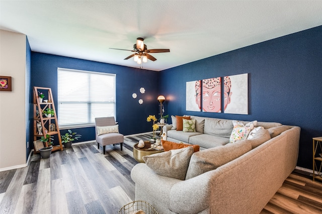 living room with wood-type flooring and ceiling fan