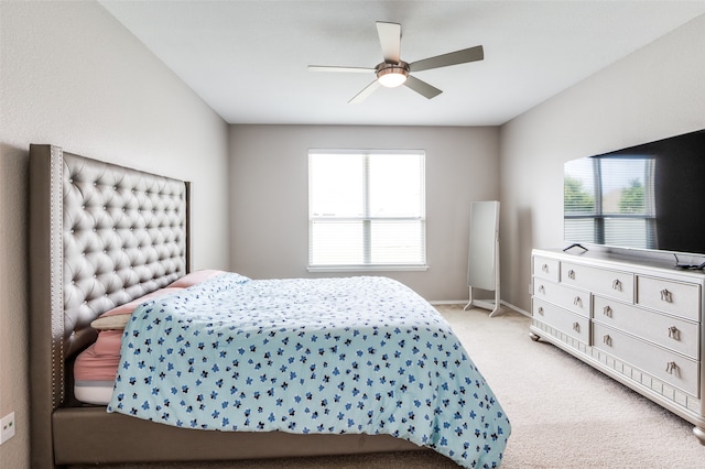 bedroom featuring multiple windows, light carpet, and ceiling fan