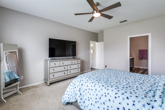 carpeted bedroom featuring ceiling fan and connected bathroom