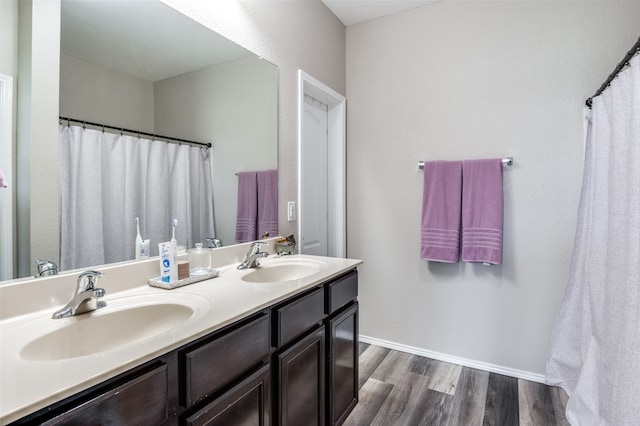 bathroom featuring hardwood / wood-style floors and double vanity