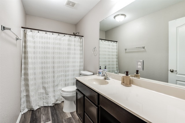 bathroom with hardwood / wood-style floors, vanity, and toilet