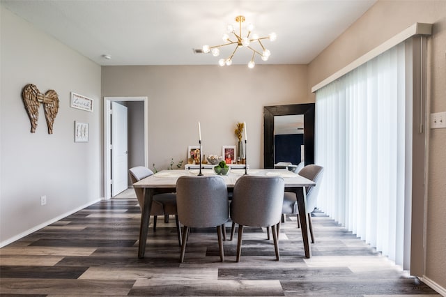 dining room with an inviting chandelier, a wealth of natural light, and hardwood / wood-style flooring