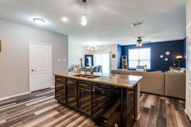 kitchen with black dishwasher, sink, dark brown cabinets, an island with sink, and dark wood-type flooring