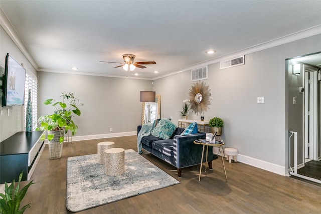 living room with crown molding, a healthy amount of sunlight, dark hardwood / wood-style flooring, and ceiling fan