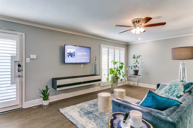 living room featuring dark hardwood / wood-style flooring, ornamental molding, and ceiling fan