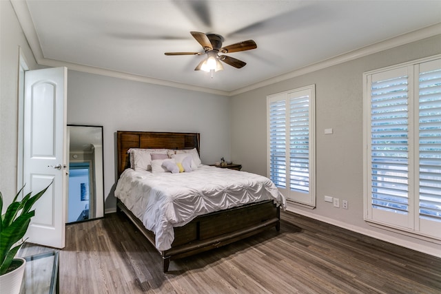 bedroom featuring dark hardwood / wood-style flooring, ornamental molding, and ceiling fan