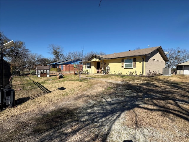 single story home with a storage shed and central air condition unit