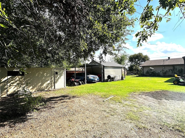 view of yard with a carport and an outdoor structure