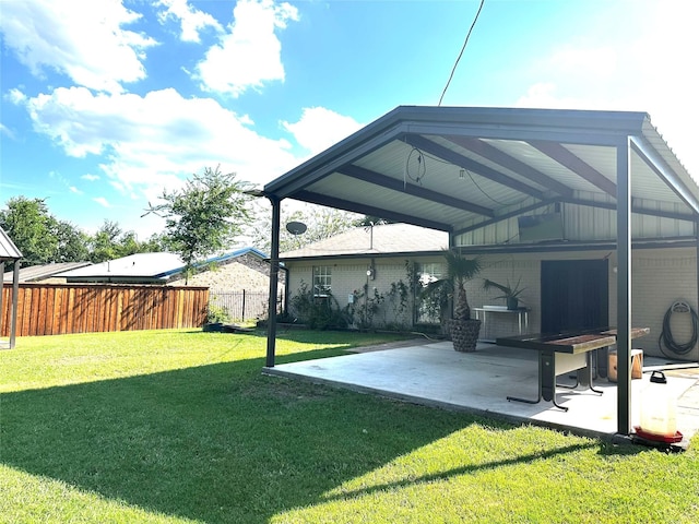 back of property with a yard and a patio