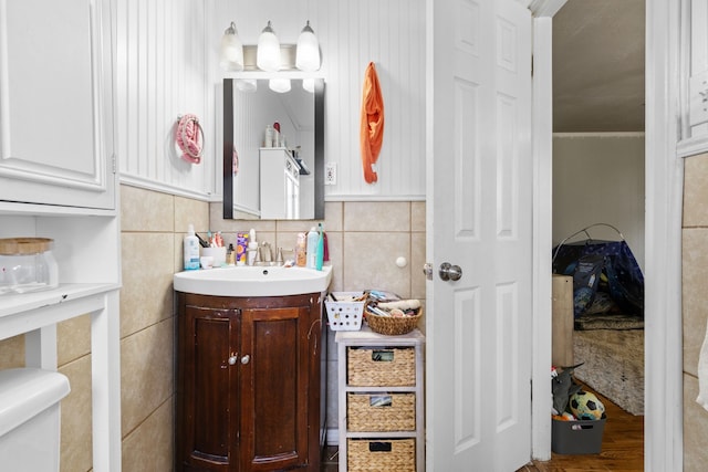 bathroom with tile walls, hardwood / wood-style floors, vanity, and toilet