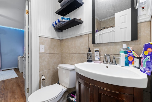 bathroom with tile walls, vanity, hardwood / wood-style flooring, and toilet