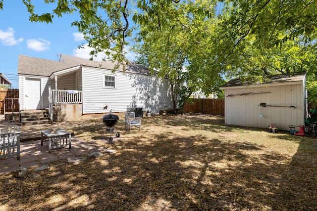 rear view of property featuring a storage shed