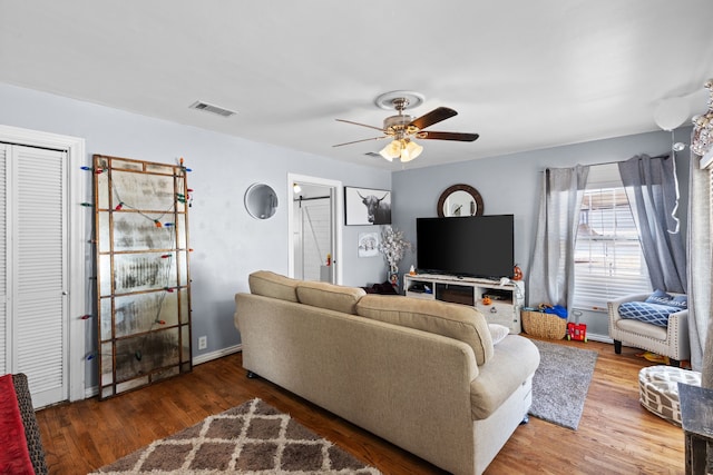 living room with ceiling fan and wood-type flooring