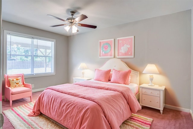 bedroom featuring light carpet, a ceiling fan, and baseboards