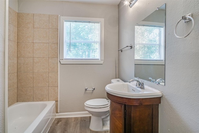 full bath featuring toilet, plenty of natural light, baseboards, and wood finished floors