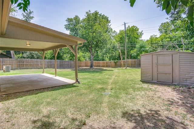 view of yard featuring a fenced backyard, a storage unit, an outdoor structure, a patio area, and central AC