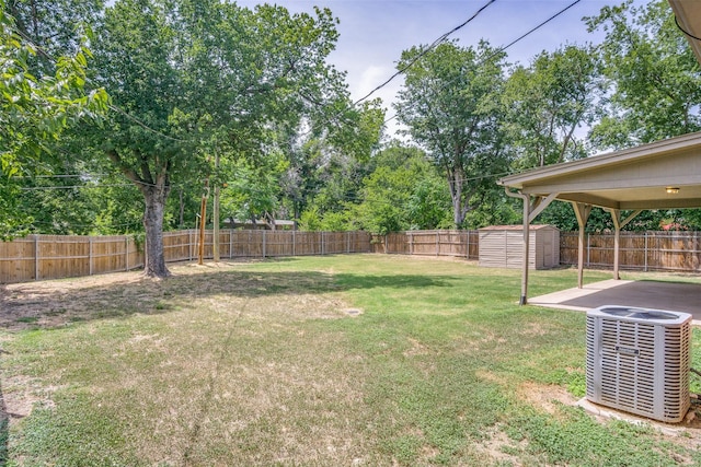 view of yard with an outbuilding, a storage shed, a fenced backyard, and cooling unit