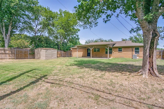 exterior space with an outbuilding, a fenced backyard, a patio, and a shed