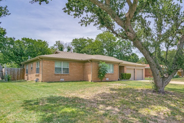 single story home featuring a garage, fence, a front lawn, and brick siding