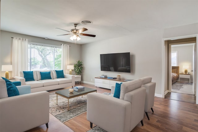 living room featuring hardwood / wood-style flooring and ceiling fan