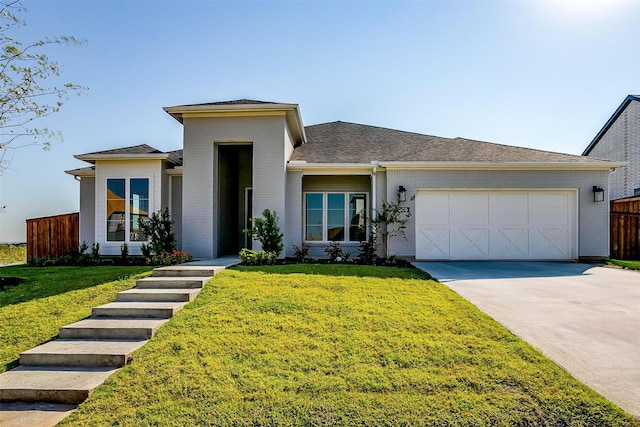 view of front of property with a front lawn and a garage