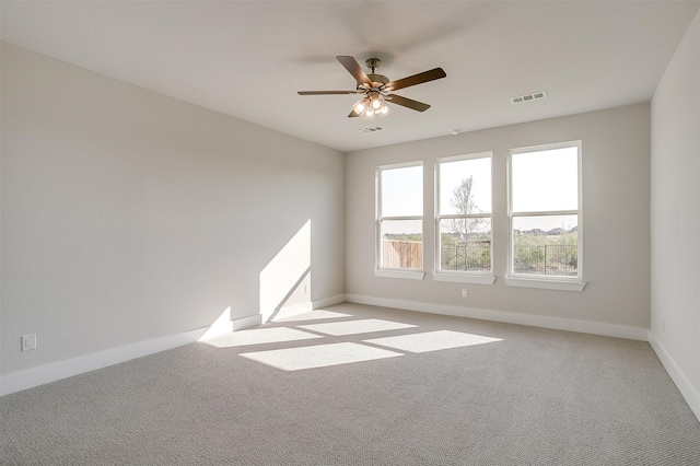 carpeted spare room featuring ceiling fan