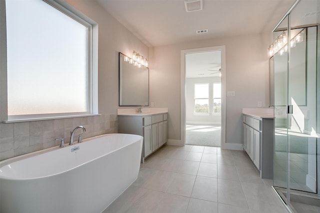 bathroom with vanity, shower with separate bathtub, ceiling fan, and tile patterned floors