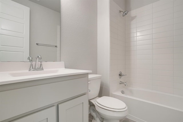 full bathroom featuring vanity, tiled shower / bath combo, and toilet