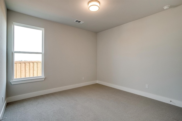 carpeted empty room with a healthy amount of sunlight